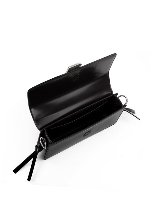 Angled over head view of wide open Nia Bag with black leather and black leather strap with silver  logo magnetic closure